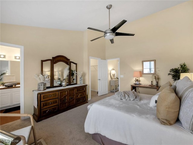 6010 Turnwood Dr, Westerville, OH 43081 - carpeted bedroom with a walk in closet, high vaulted ceiling, connected bathroom, ceiling fan, and a closet