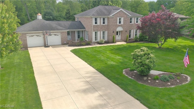 1818 Steiner St NW, North Canton, OH 44720 - colonial home with an attached garage, brick siding, driveway, and a front lawn