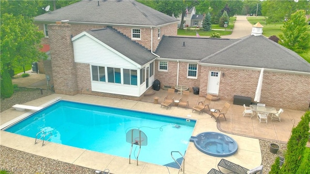 1818 Steiner St NW, North Canton, OH 44720 - view of pool featuring a patio area, a sunroom, a pool with connected hot tub, and central AC unit