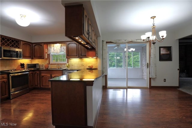 1818 Steiner St NW, North Canton, OH 44720 - kitchen featuring stainless steel appliances, dark wood finished floors, plenty of natural light, and a chandelier