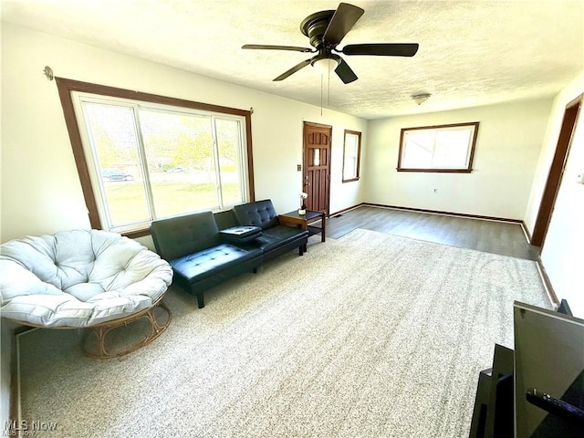 3242 State Route 43, Mogadore, OH 44260 - living area featuring plenty of natural light, ceiling fan, wood finished floors, and baseboards
