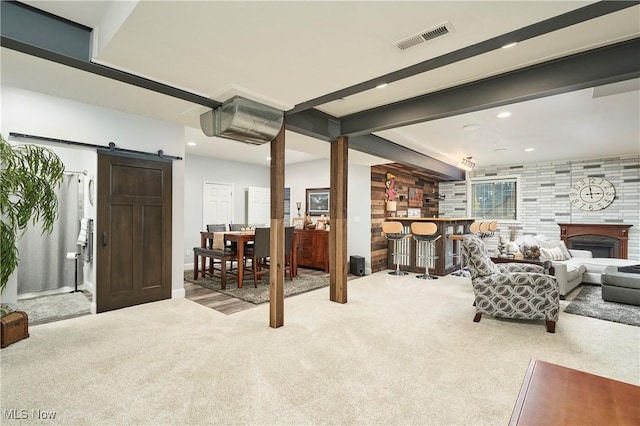 7355 Hunters Glen Ln, Seville, OH 44273 - carpeted living area featuring a bar, a barn door, and recessed lighting