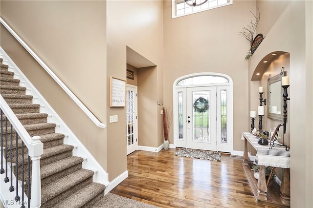 7355 Hunters Glen Ln, Seville, OH 44273 - entrance foyer with wood finished floors, stairs, a towering ceiling, and baseboards