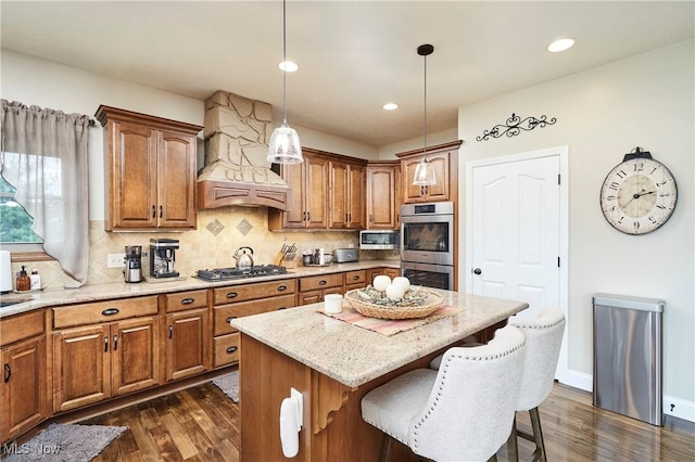 7355 Hunters Glen Ln, Seville, OH 44273 - kitchen featuring a kitchen bar, dark wood-type flooring, brown cabinets, and recessed lighting