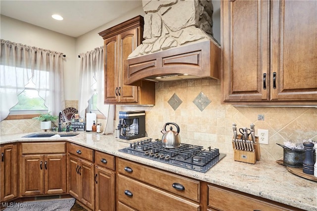 7355 Hunters Glen Ln, Seville, OH 44273 - kitchen featuring gas cooktop, a sink, tasteful backsplash, and light stone counters