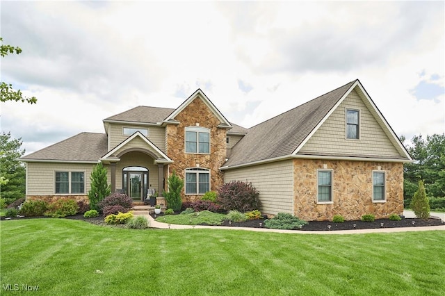 7355 Hunters Glen Ln, Seville, OH 44273 - view of front of house with stone siding, a front yard, and roof with shingles