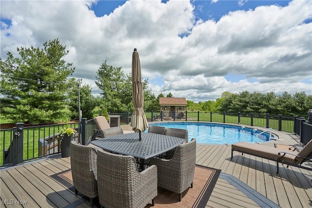 7355 Hunters Glen Ln, Seville, OH 44273 - view of swimming pool with outdoor dining area, a wooden deck, and view of wooded area