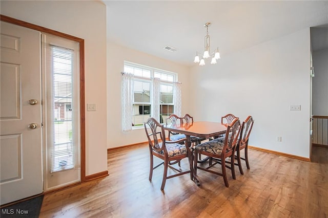 217 Greenbriar Ln, Dalton, OH 44618 - dining room featuring wood finished floors, a chandelier, and baseboards
