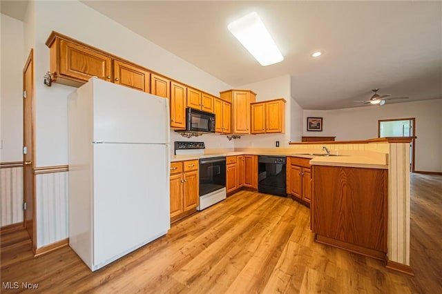 217 Greenbriar Ln, Dalton, OH 44618 - kitchen featuring black appliances, a sink, a peninsula, light countertops, and light wood finished floors