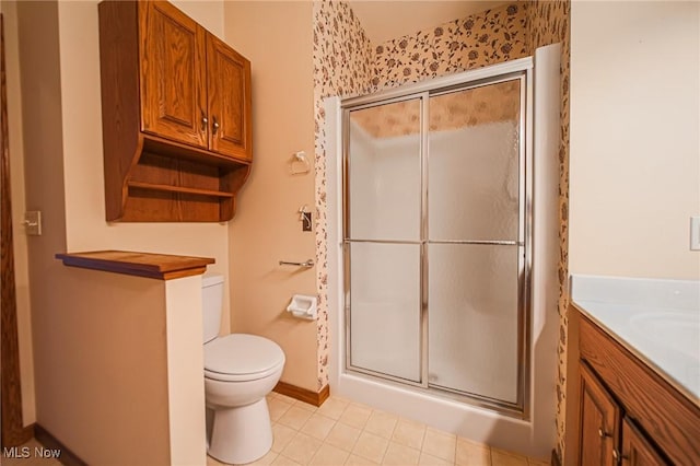 217 Greenbriar Ln, Dalton, OH 44618 - bathroom featuring a stall shower, toilet, vanity, baseboards, and tile patterned floors