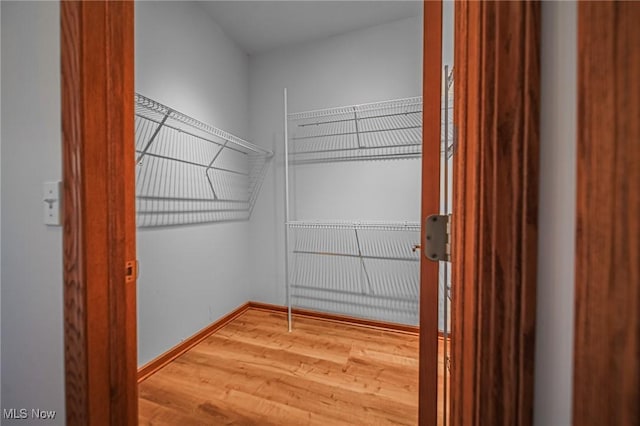 217 Greenbriar Ln, Dalton, OH 44618 - walk in closet featuring wood finished floors