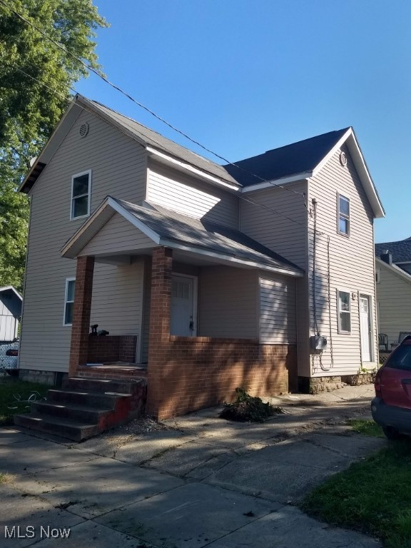 353 3rd St NW, Barberton, OH 44203 - view of front of house featuring a porch and brick siding