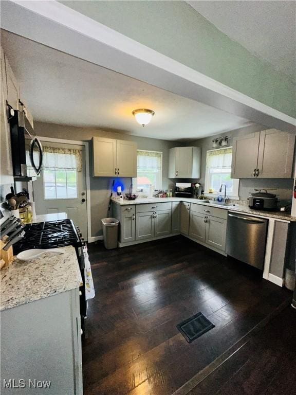 418 Main St, Philo, OH 43771 - kitchen with stainless steel appliances, light countertops, plenty of natural light, and dark wood-type flooring