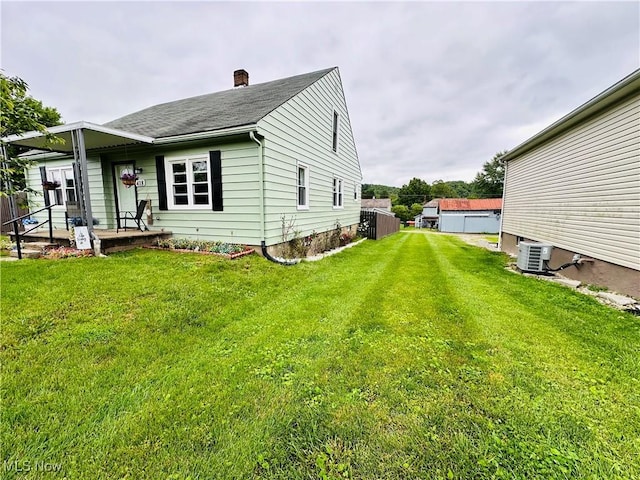 418 Main St, Philo, OH 43771 - view of side of property featuring a chimney, a yard, and roof with shingles