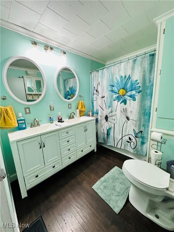 418 Main St, Philo, OH 43771 - bathroom with toilet, wood finished floors, double vanity, and curtained shower