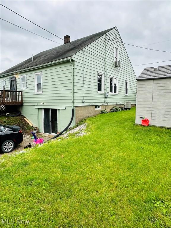 418 Main St, Philo, OH 43771 - back of property featuring a lawn, cooling unit, a chimney, and a deck