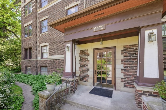 2472 Overlook Rd Unit 11, Cleveland Heights, OH 44106 - view of exterior entry featuring brick siding and a porch