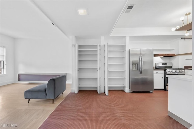 2472 Overlook Rd Unit 11, Cleveland Heights, OH 44106 - kitchen featuring appliances with stainless steel finishes, open shelves, white cabinetry, under cabinet range hood, and baseboards