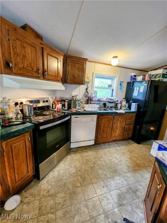 6960 Bluebell Rd, Cumberland, OH 43732 - kitchen featuring stainless steel electric range oven, white dishwasher, freestanding refrigerator, a textured ceiling, and brown cabinetry