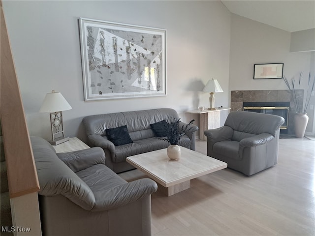 629 Main St, Vermilion, OH 44089 - living room with wood finished floors, vaulted ceiling, and a premium fireplace