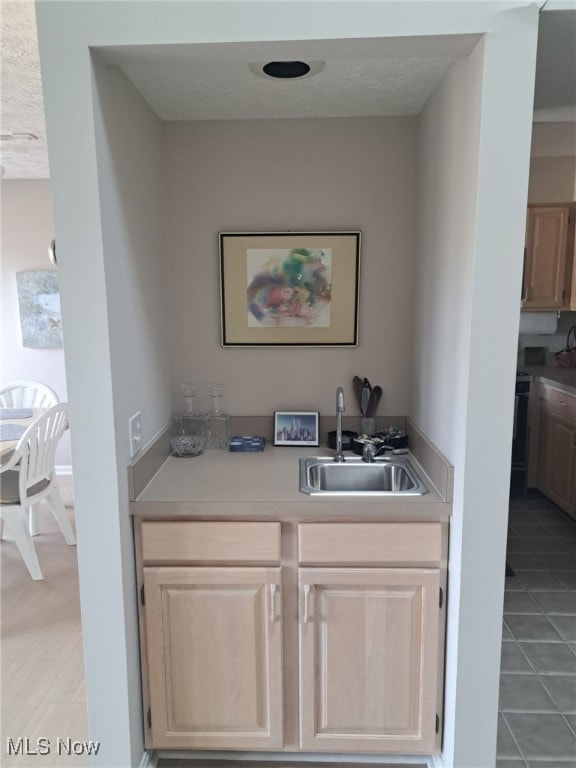 629 Main St, Vermilion, OH 44089 - bar area with a sink, light tile patterned floors, and a textured ceiling