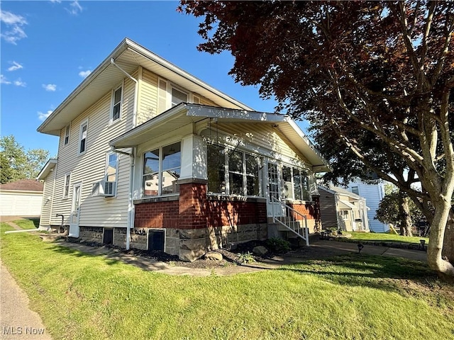 610 N 5th St, Cambridge, OH 43725 - view of side of property featuring a yard, a sunroom, and cooling unit