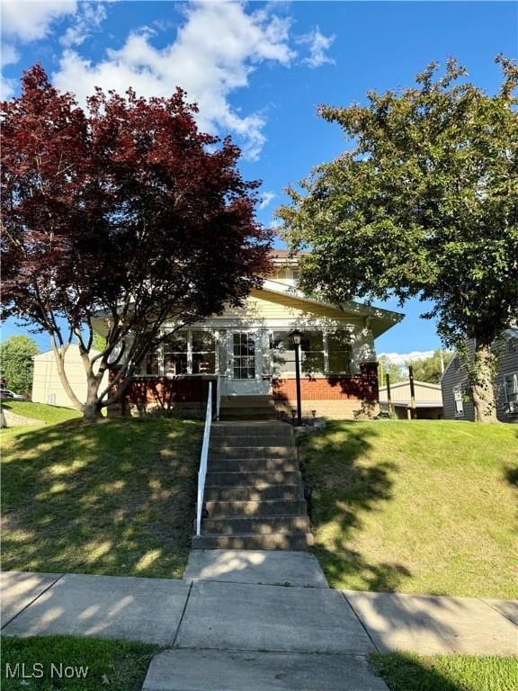 610 N 5th St, Cambridge, OH 43725 - view of property hidden behind natural elements featuring a front lawn