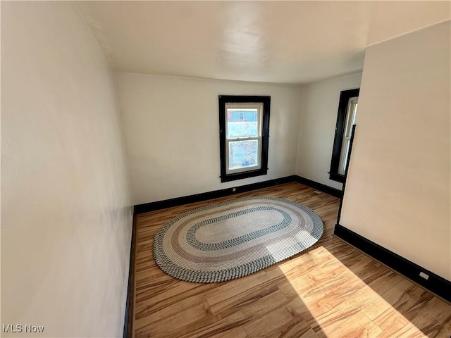 610 N 5th St, Cambridge, OH 43725 - empty room with wood finished floors and baseboards