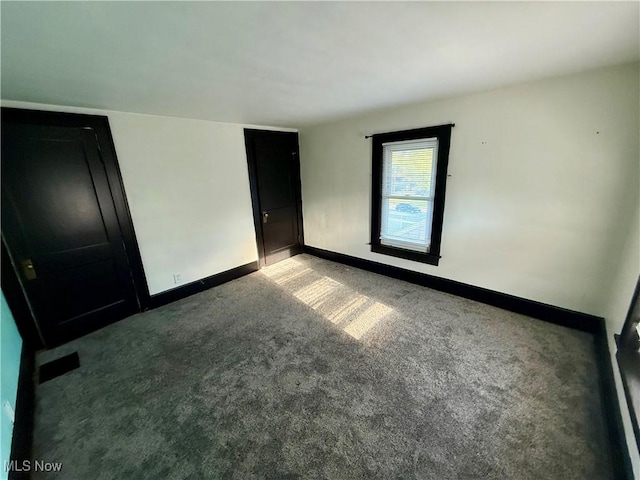 610 N 5th St, Cambridge, OH 43725 - unfurnished bedroom featuring carpet floors and baseboards