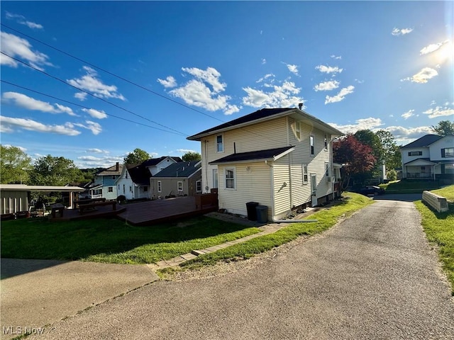 610 N 5th St, Cambridge, OH 43725 - view of side of property with a residential view and a lawn