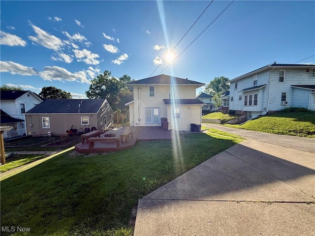 610 N 5th St, Cambridge, OH 43725 - view of front of home with a wooden deck, a front lawn, and a residential view