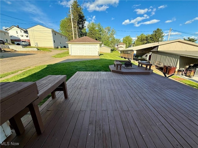 610 N 5th St, Cambridge, OH 43725 - deck with a detached garage, a yard, an outdoor structure, and a residential view