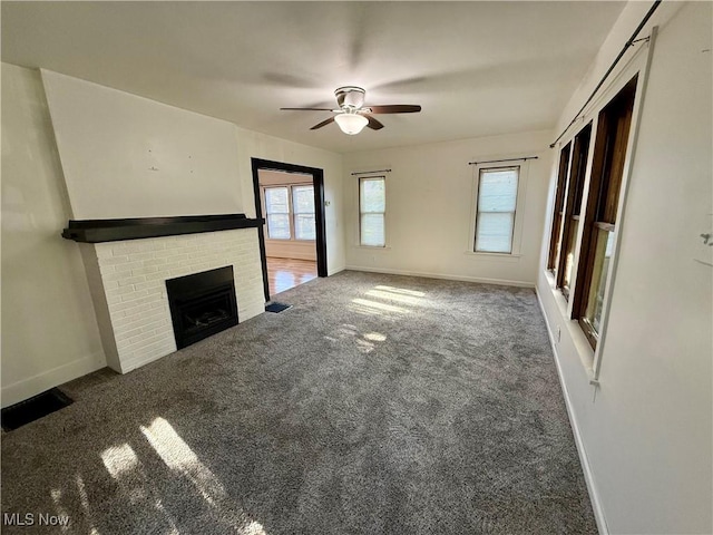 610 N 5th St, Cambridge, OH 43725 - unfurnished living room with ceiling fan, carpet floors, baseboards, and a brick fireplace