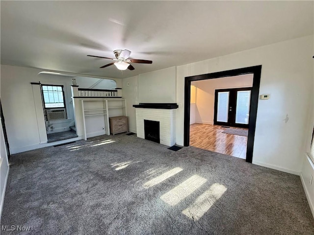 610 N 5th St, Cambridge, OH 43725 - unfurnished living room featuring carpet flooring, ceiling fan, a fireplace, and baseboards