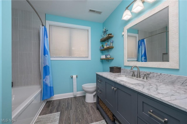 4184 Meadowview Dr NW, Canton, OH 44718 - full bath featuring vanity, toilet, wood finished floors, baseboards, and shower / bathtub combination with curtain