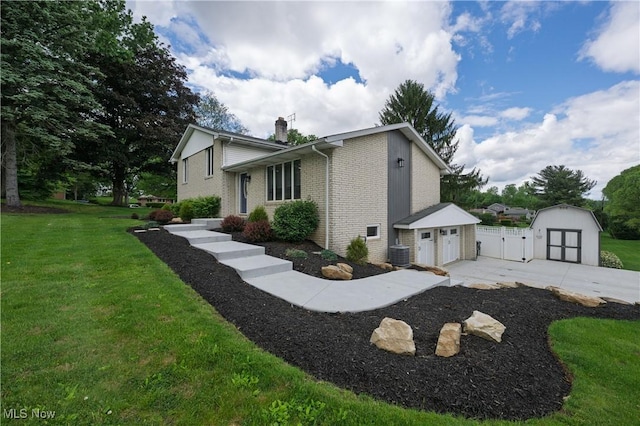 4184 Meadowview Dr NW, Canton, OH 44718 - view of side of home with a chimney, central AC unit, brick siding, a gate, and driveway