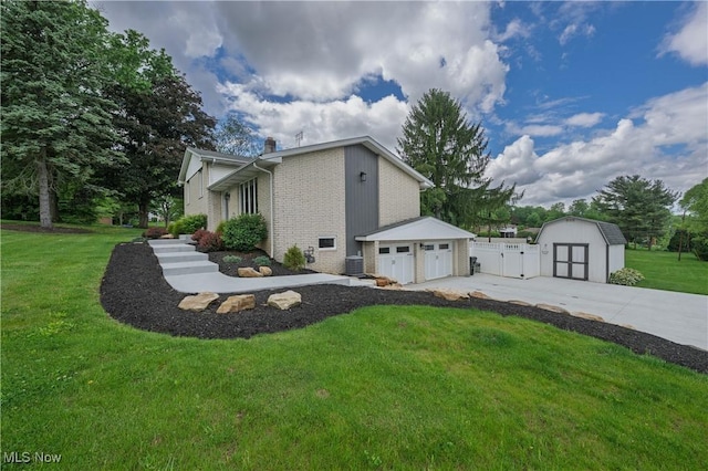 4184 Meadowview Dr NW, Canton, OH 44718 - view of side of home with a garage, a chimney, driveway, brick siding, and a gate