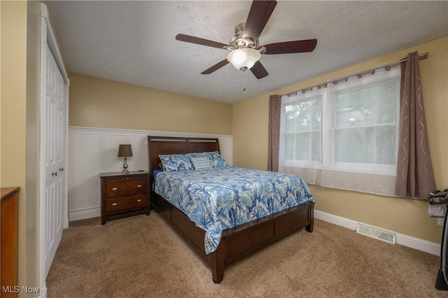 4184 Meadowview Dr NW, Canton, OH 44718 - carpeted bedroom with a textured ceiling and a ceiling fan