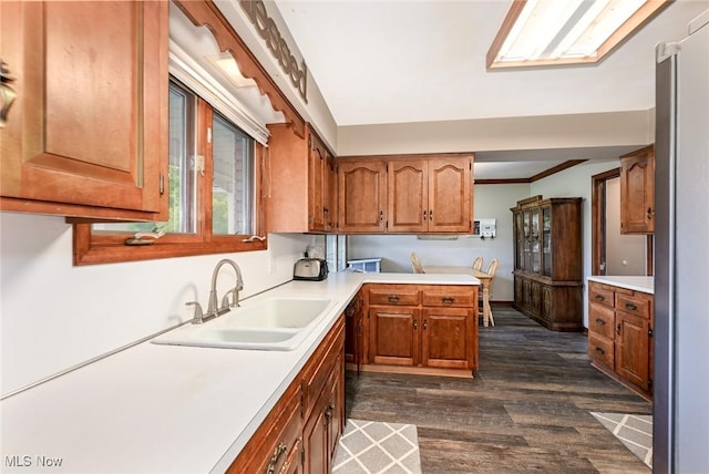 12115 Fowlers Mill Rd, Chardon, OH 44024 - kitchen featuring a sink, light countertops, dark wood-style floors, and brown cabinets