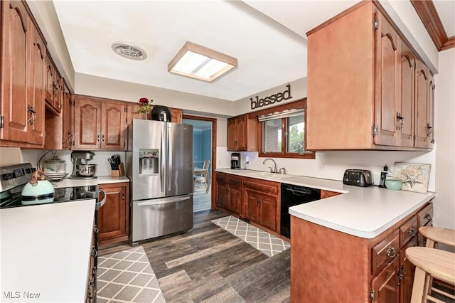 12115 Fowlers Mill Rd, Chardon, OH 44024 - kitchen featuring stainless steel appliances, dark wood-style floors, light countertops, a peninsula, and a sink