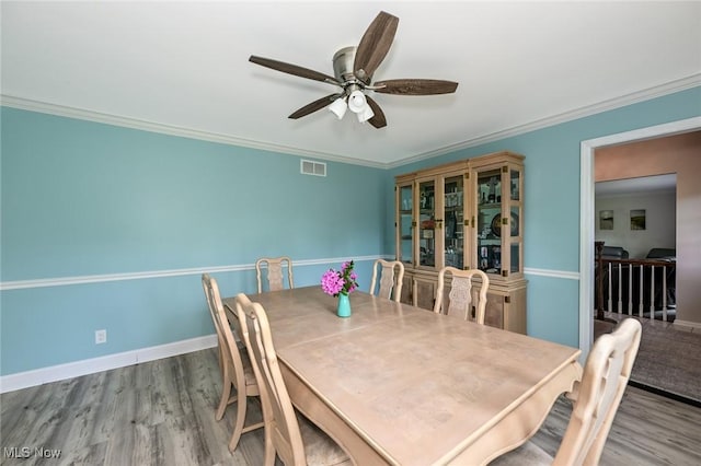 12115 Fowlers Mill Rd, Chardon, OH 44024 - dining room featuring a ceiling fan, wood finished floors, crown molding, and baseboards