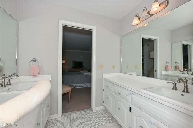 12115 Fowlers Mill Rd, Chardon, OH 44024 - ensuite bathroom featuring tile patterned floors, two vanities, and baseboards