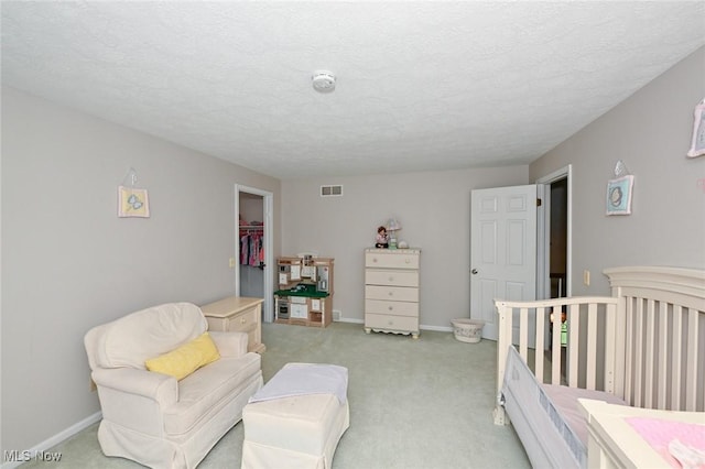 12115 Fowlers Mill Rd, Chardon, OH 44024 - bedroom with light carpet, a walk in closet, baseboards, and a textured ceiling