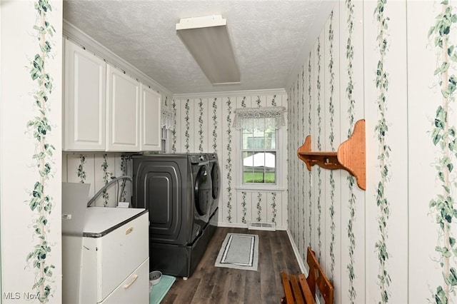 12115 Fowlers Mill Rd, Chardon, OH 44024 - laundry room featuring cabinet space, washer and clothes dryer, wallpapered walls, dark wood-type flooring, and a textured ceiling
