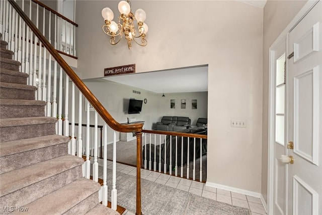 12115 Fowlers Mill Rd, Chardon, OH 44024 - stairs with tile patterned floors, baseboards, a towering ceiling, and a chandelier