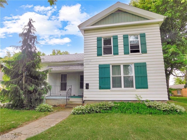 192 Walnut St, Geneva, OH 44041 - greek revival house featuring a porch, a front yard, and roof with shingles