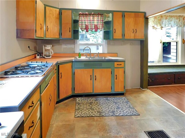 192 Walnut St, Geneva, OH 44041 - kitchen with a sink, open shelves, white gas cooktop, and light countertops