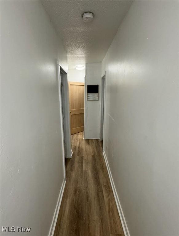 666 Parkwood Rd, Cleveland, OH 44108 - corridor featuring dark wood-style flooring, a textured ceiling, and baseboards