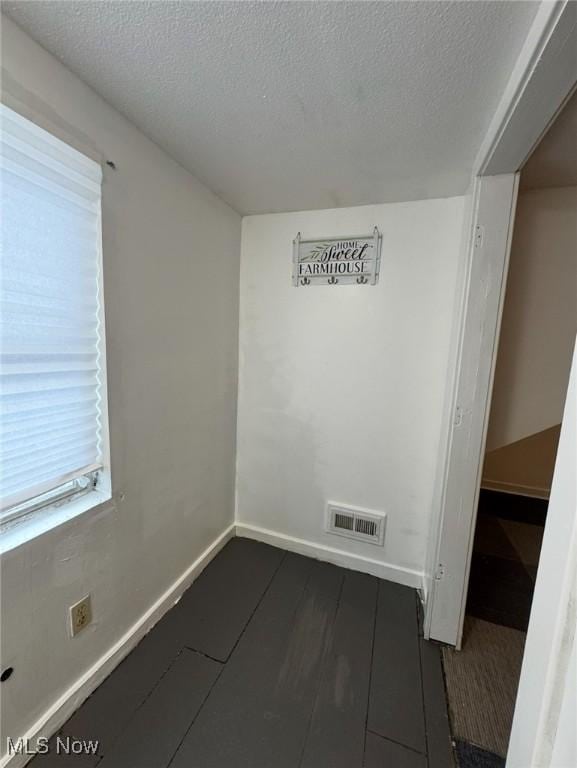 666 Parkwood Rd, Cleveland, OH 44108 - spare room with a textured ceiling and baseboards