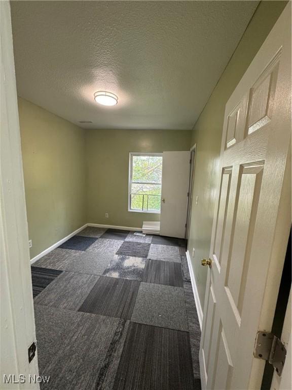 666 Parkwood Rd, Cleveland, OH 44108 - spare room with a textured ceiling and baseboards